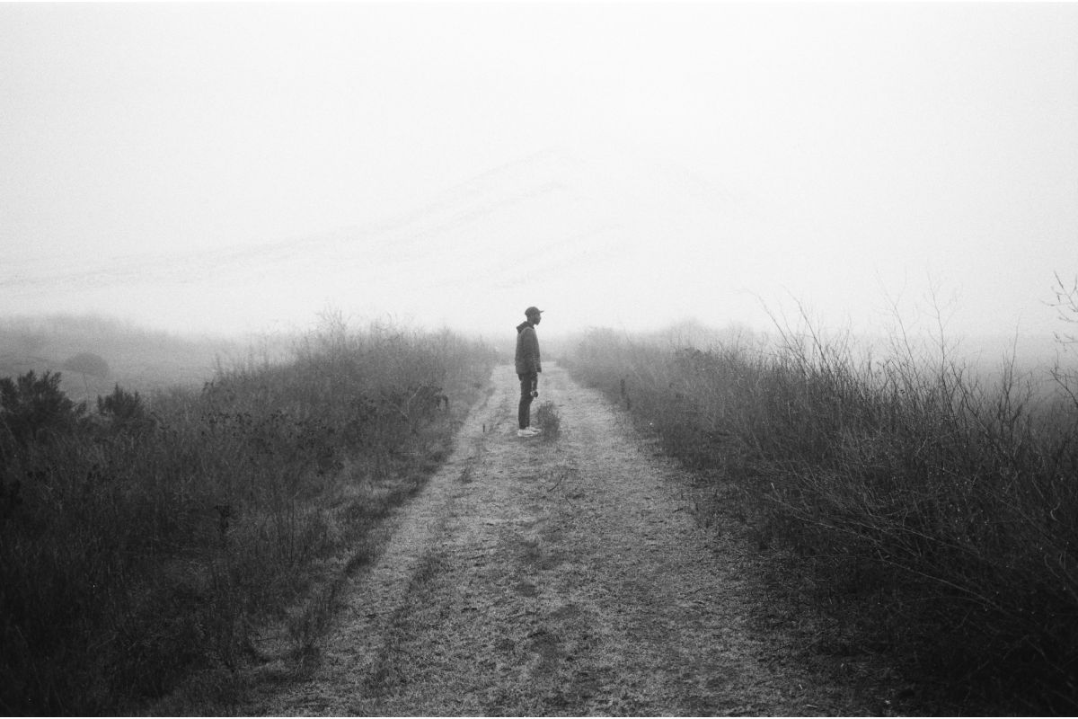 Man in a field taken with lomography potsdam kino black and white 35mm film