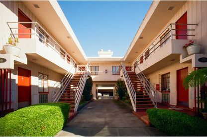 sunlit apartment block with clear skies taken with lomography colour negative 35mm film