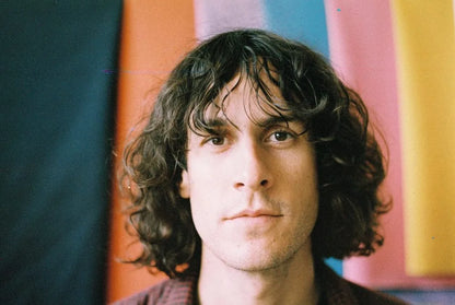 Sample photo of a man with long curly hair by wolfen nc500 35mm film